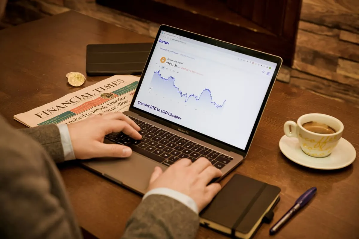 Trader reviewing automated trading results on laptop
